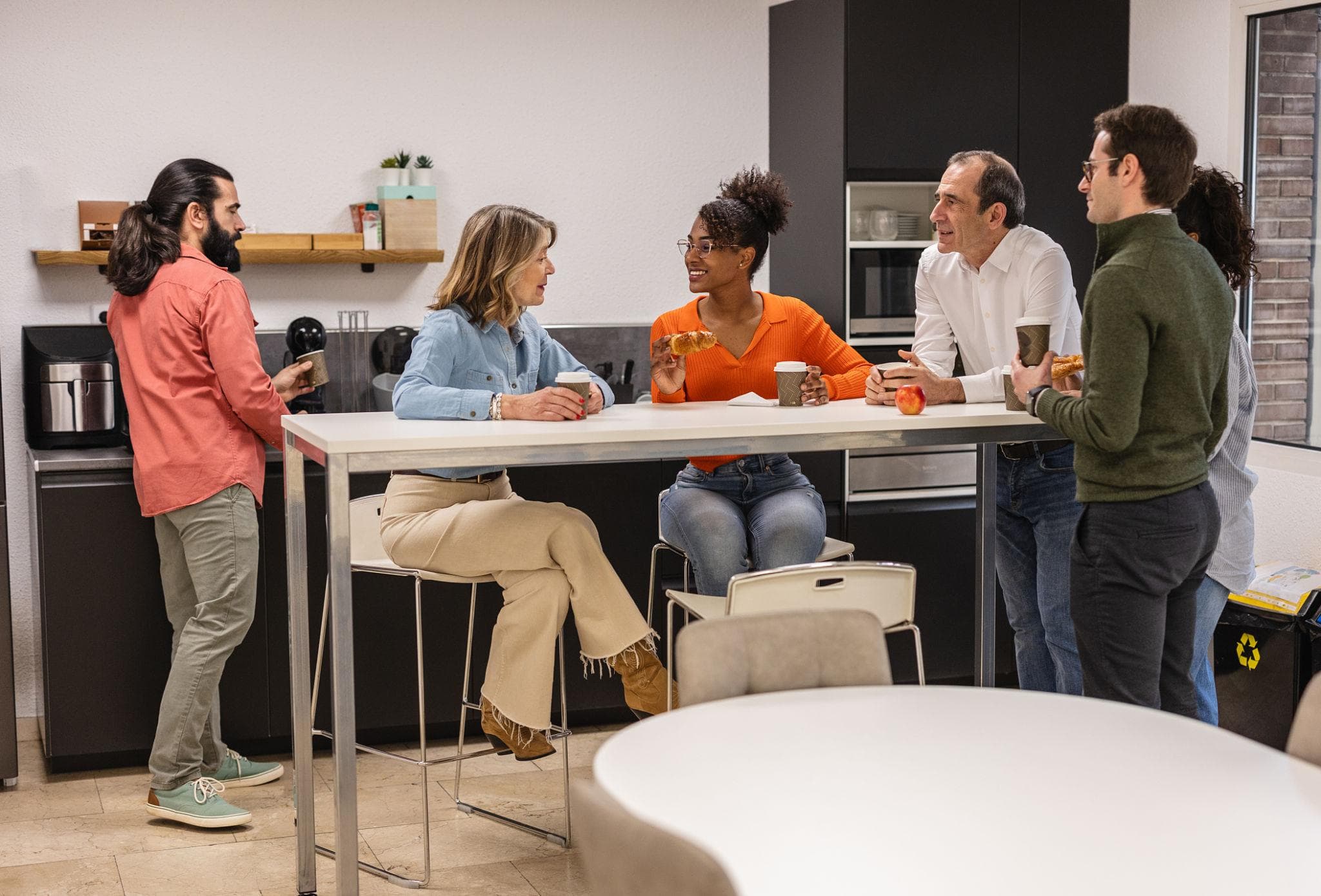 Employees enjoying refreshments in a modern workplace break room